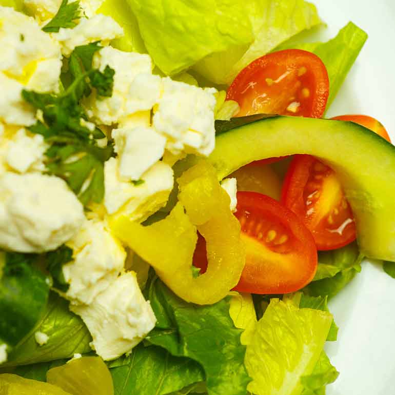 Green salad with avocado, tomatoes and feta cheese