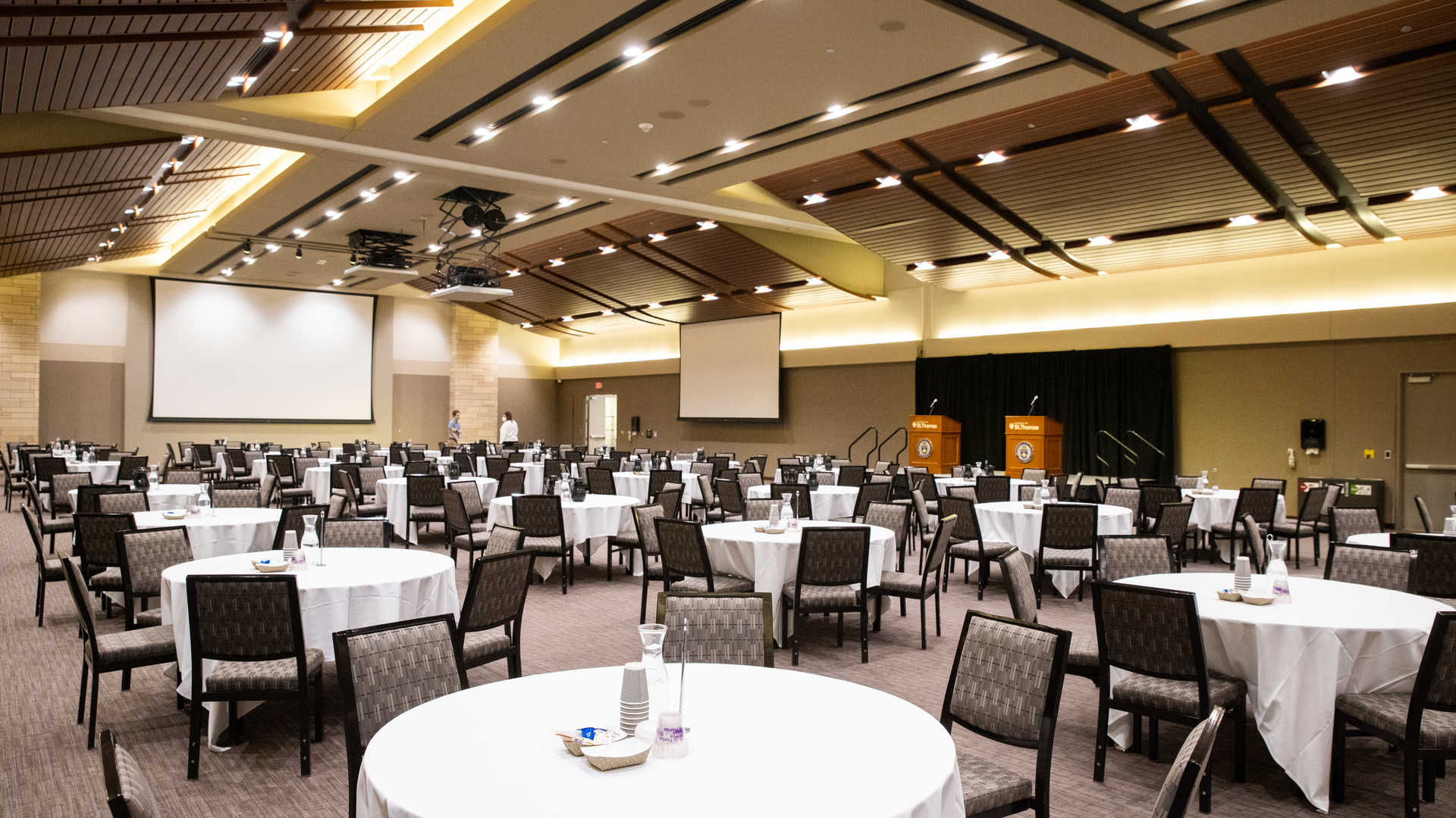 Set tables stand ready in the James B. Woulfe Alumni Hall