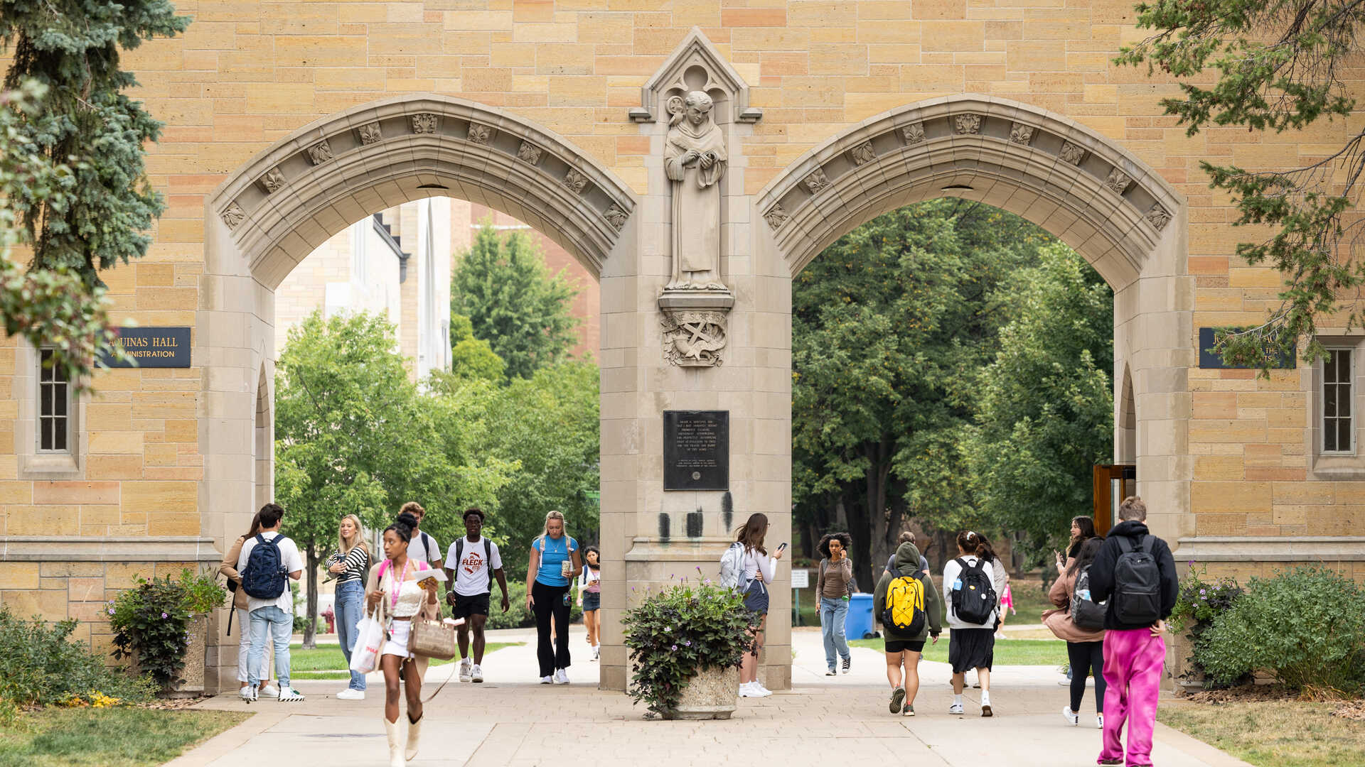 Students walk through St. Thomas Arches