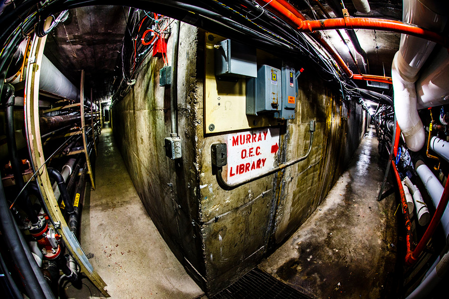 A fork in the underground tunnels with a sign pointing right for Murray, O.E.C. and Library