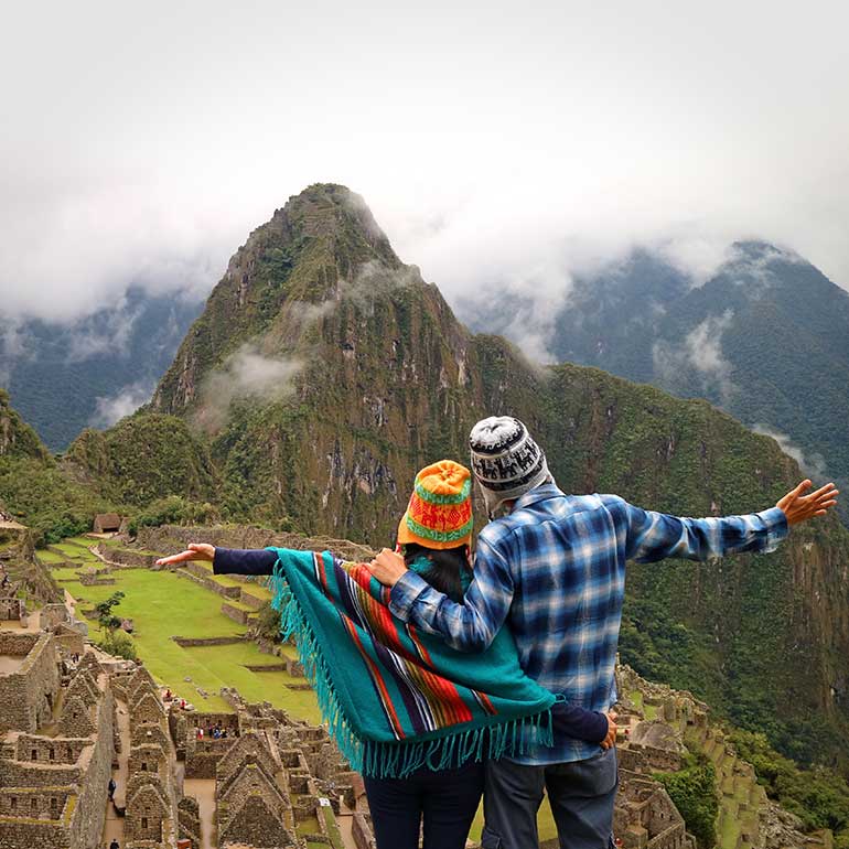 Couple pose in front of Machu Pichu