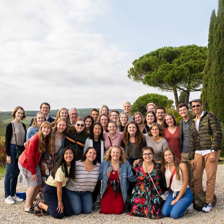 Students and faculty pose at vineyard