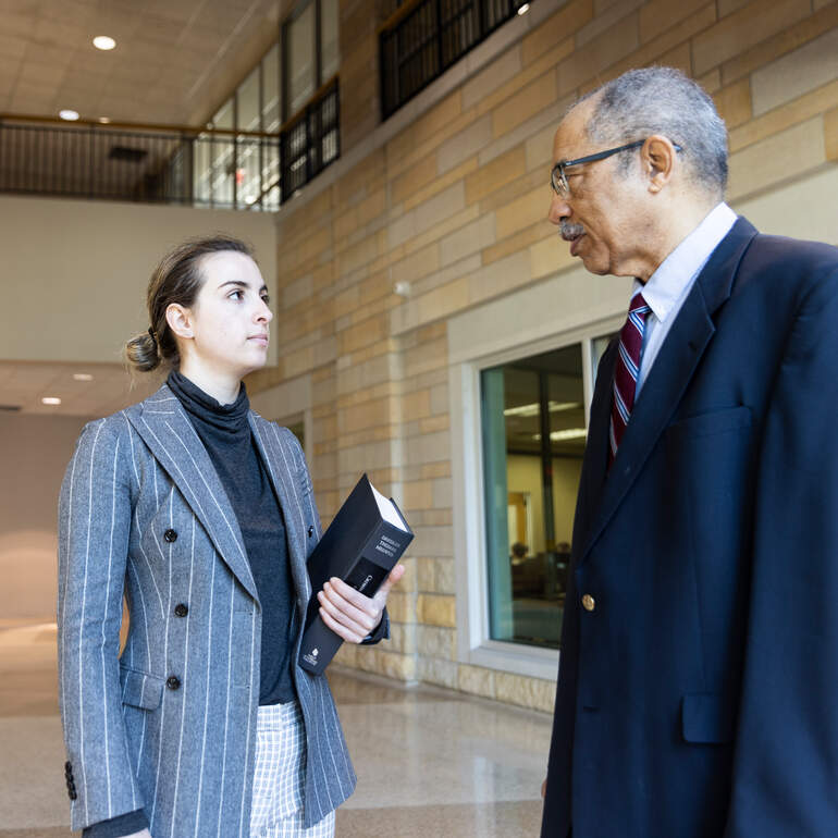 Law student and professor discussing a case