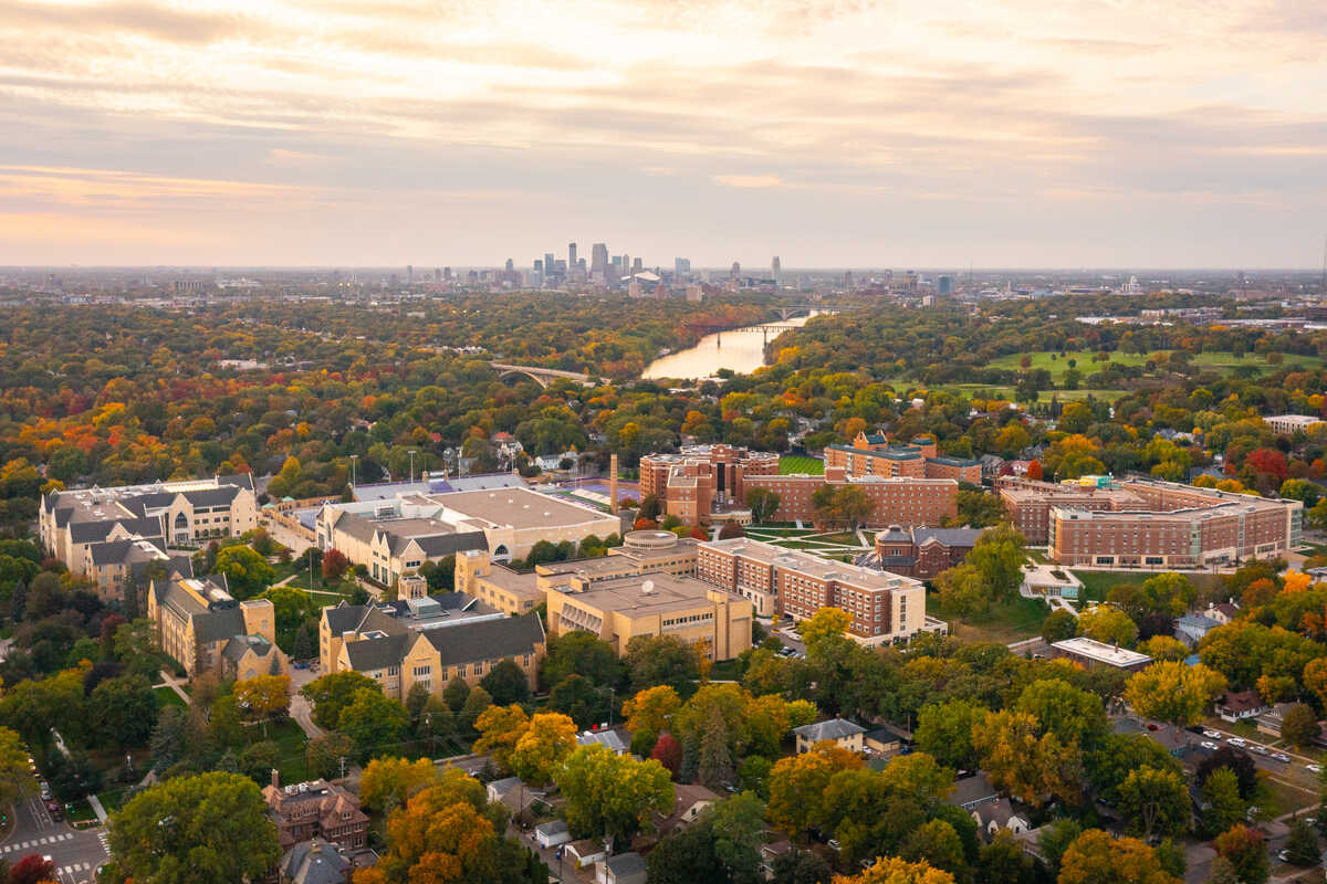 aerial view of the st paul campus with the mississippi river and minneapolis skyline