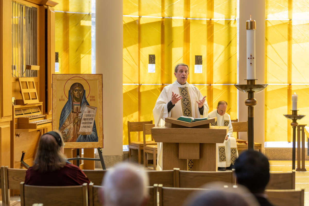 Fr. Collins leads mass inside Chapel of St. Thomas More