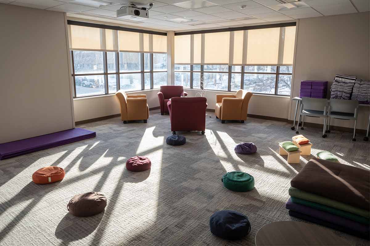 Meditation space with chairs and floor pillows
