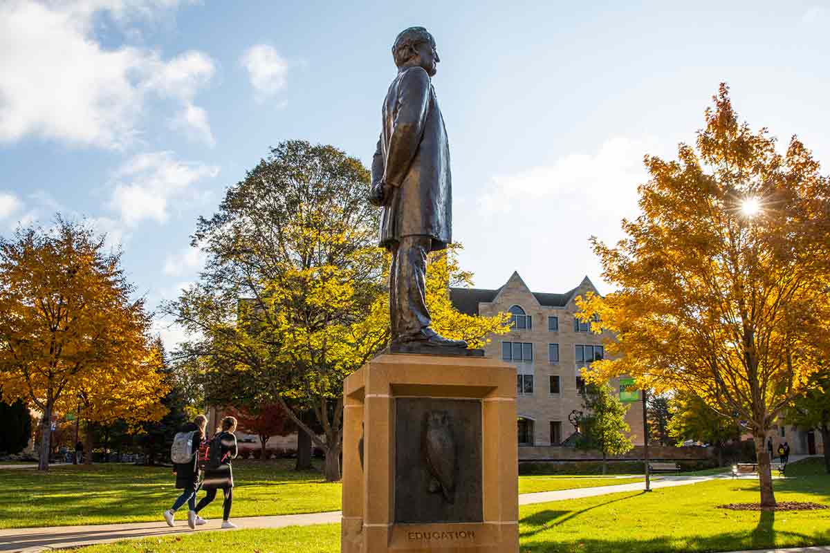 Students pass John Ireland Statue