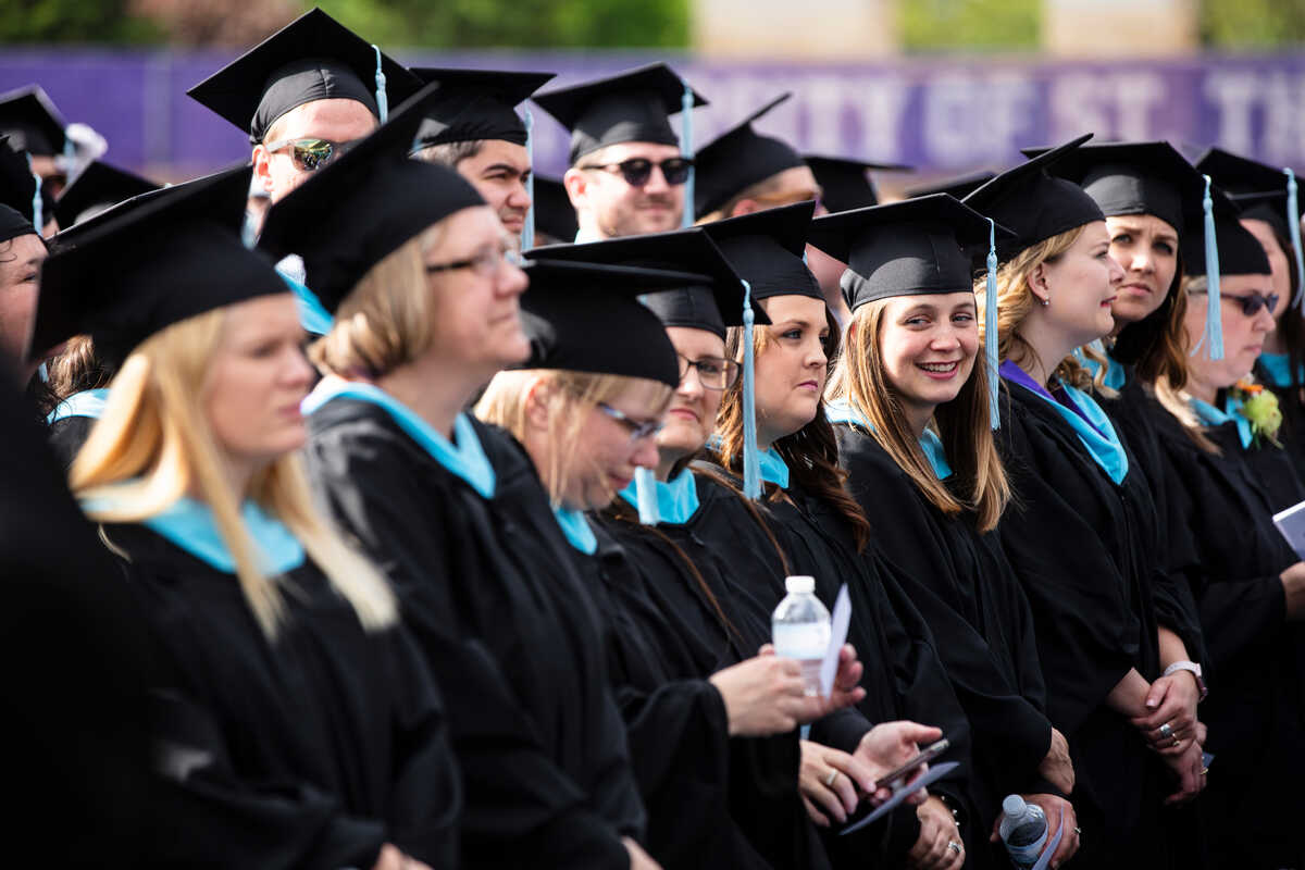Students sitting during graduation in caps and gowns