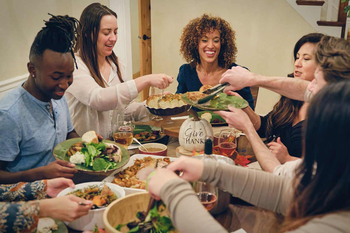 Friends and family eating Thanksgiving dinner