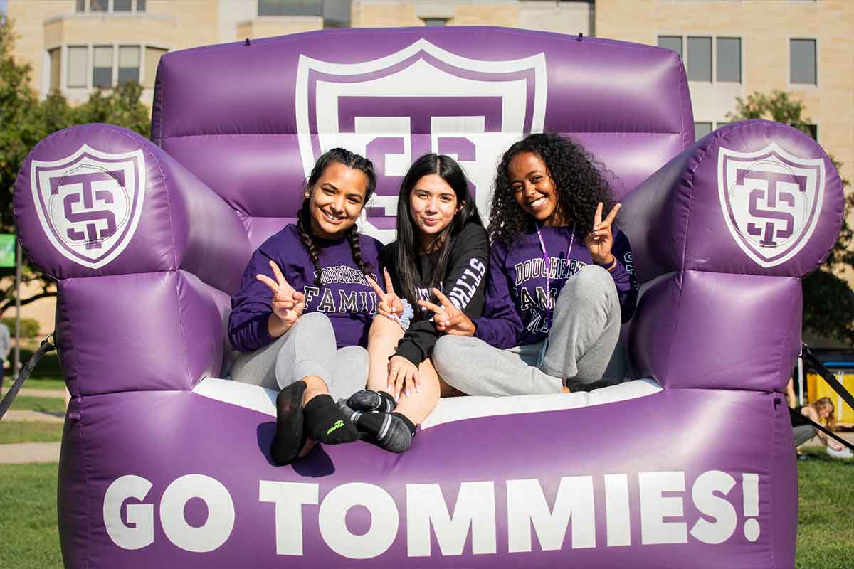 Students sitting on large chair