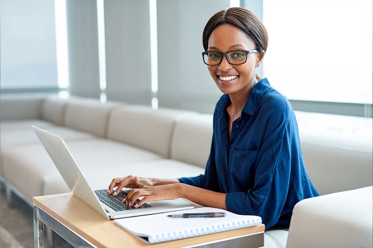 Smiling woman using laptop 
