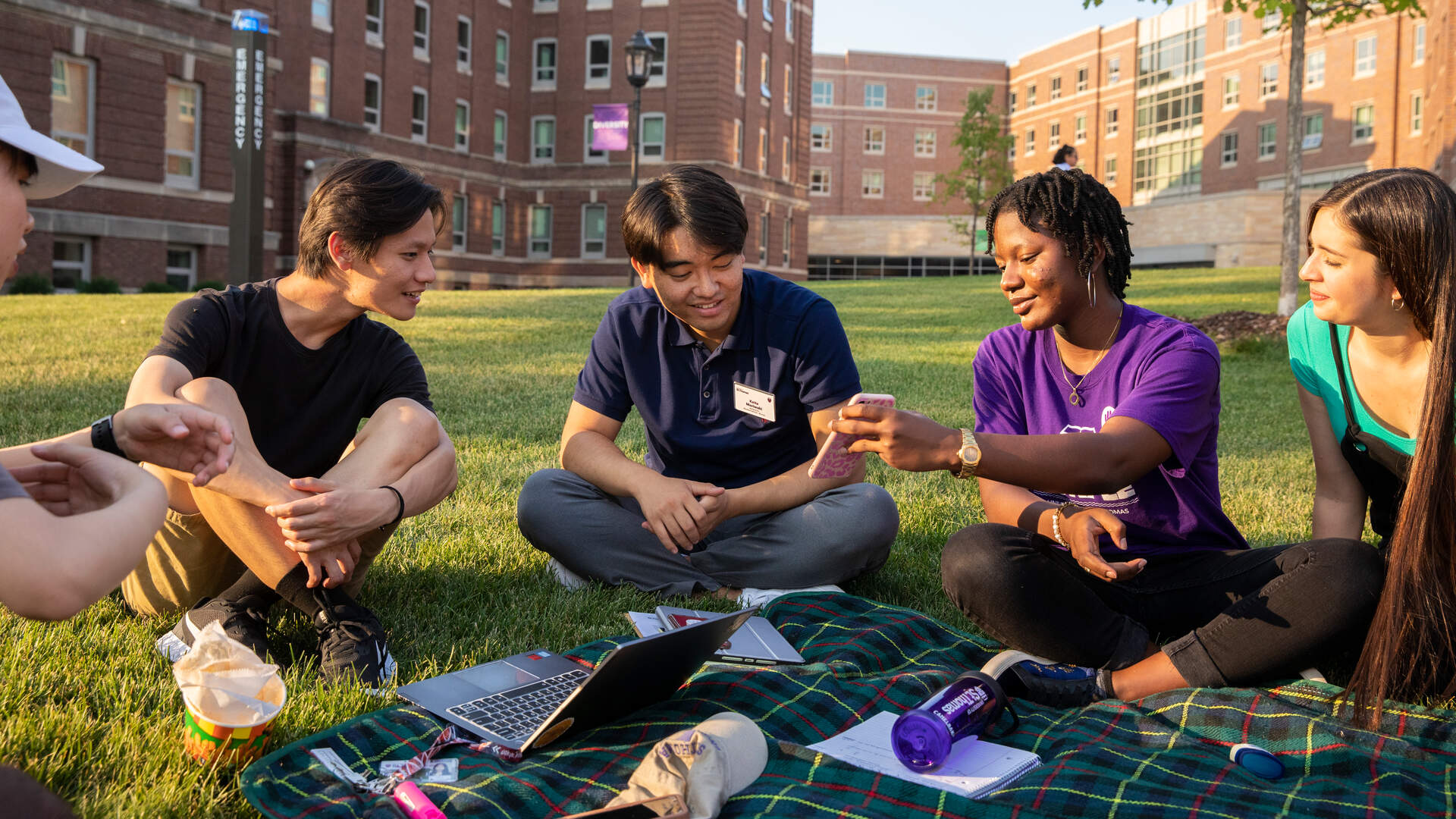 Group of students smiling on the lawn
