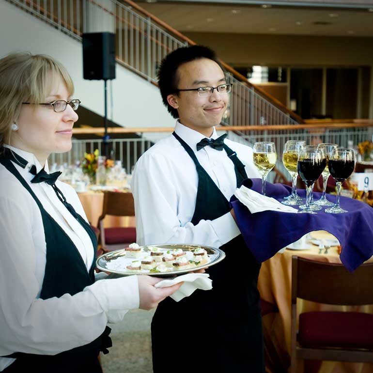 Student caterers serve appetizers and wine