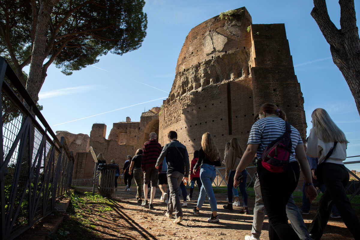 Students walking by ancient Rome ruins