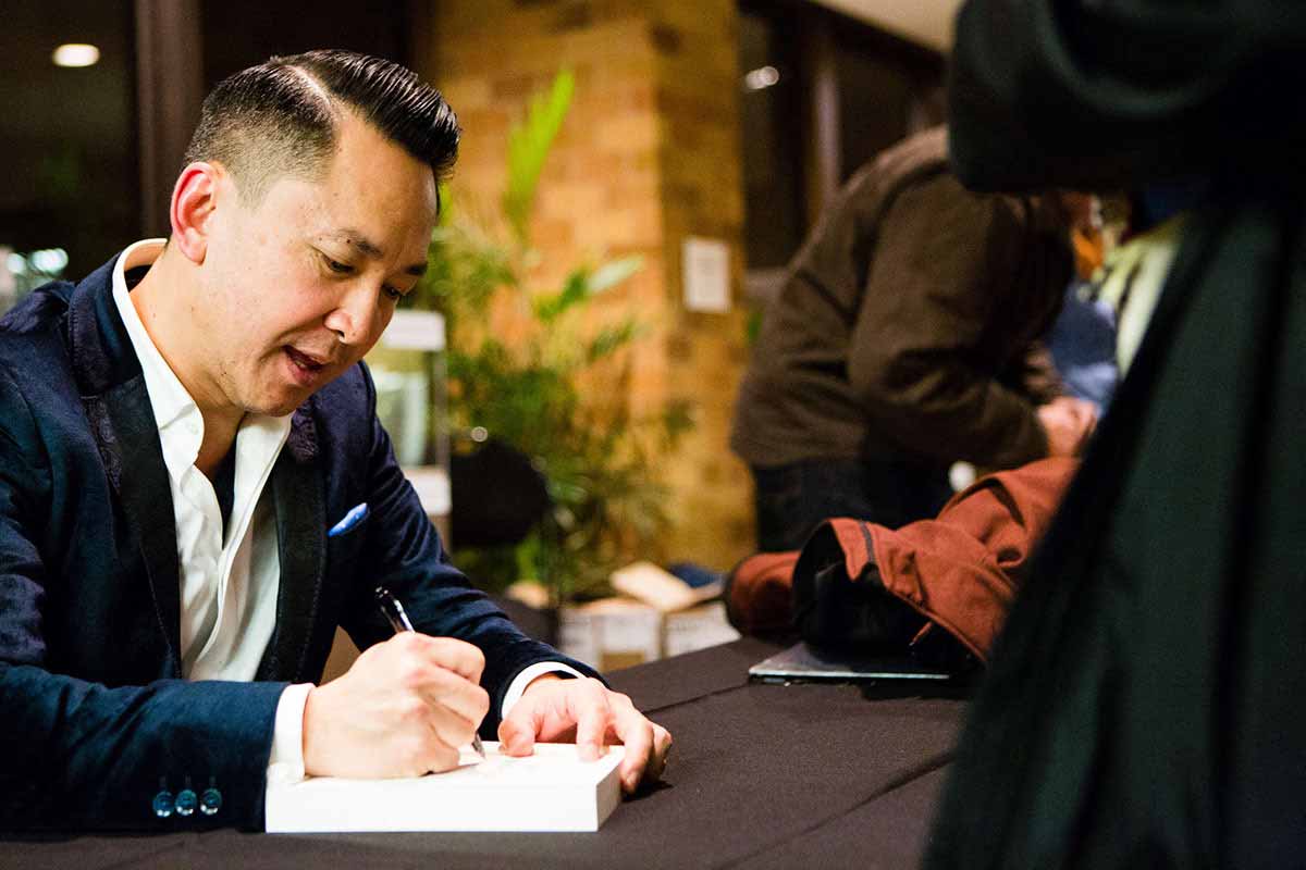 Viet Thanh Ngueyn, author, signs books for readers during the Viet Thanh Ngueyn Lecture and Book Signing in O'Shaughnessy Educational Center Auditorium.