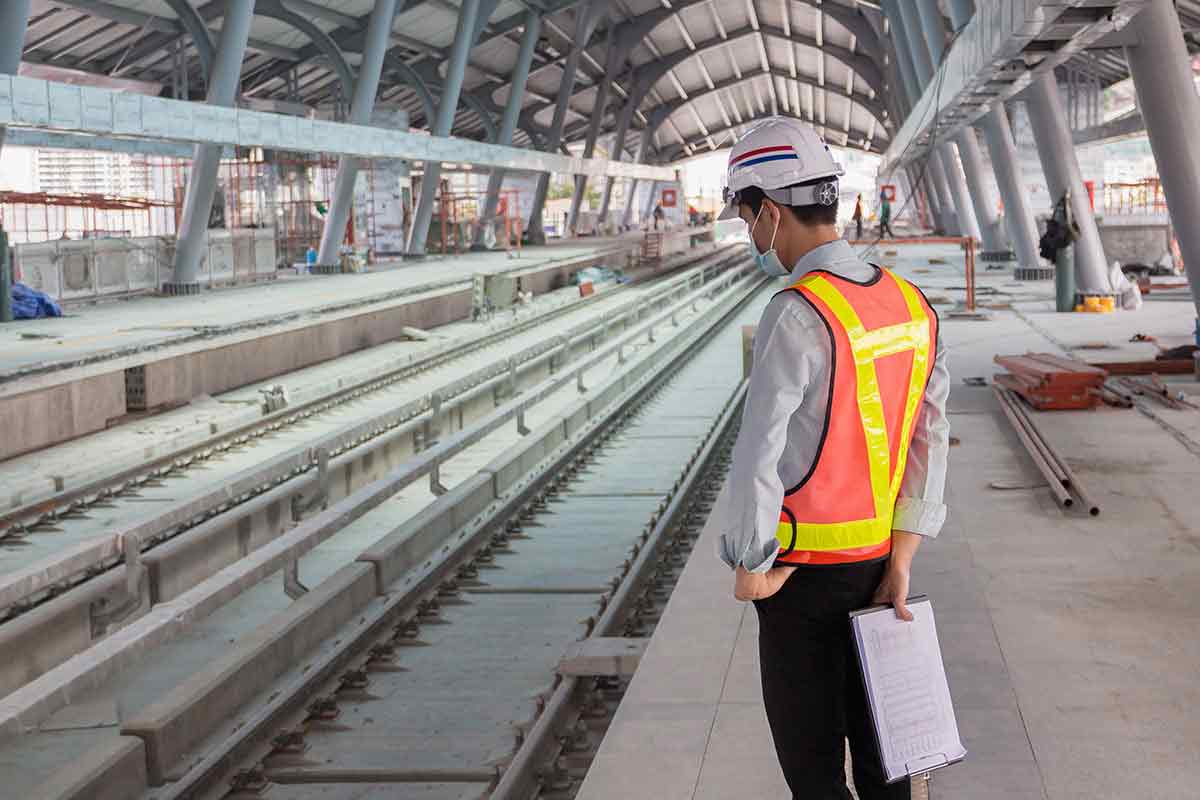 An engineer overlooks a railway station that is under construction.