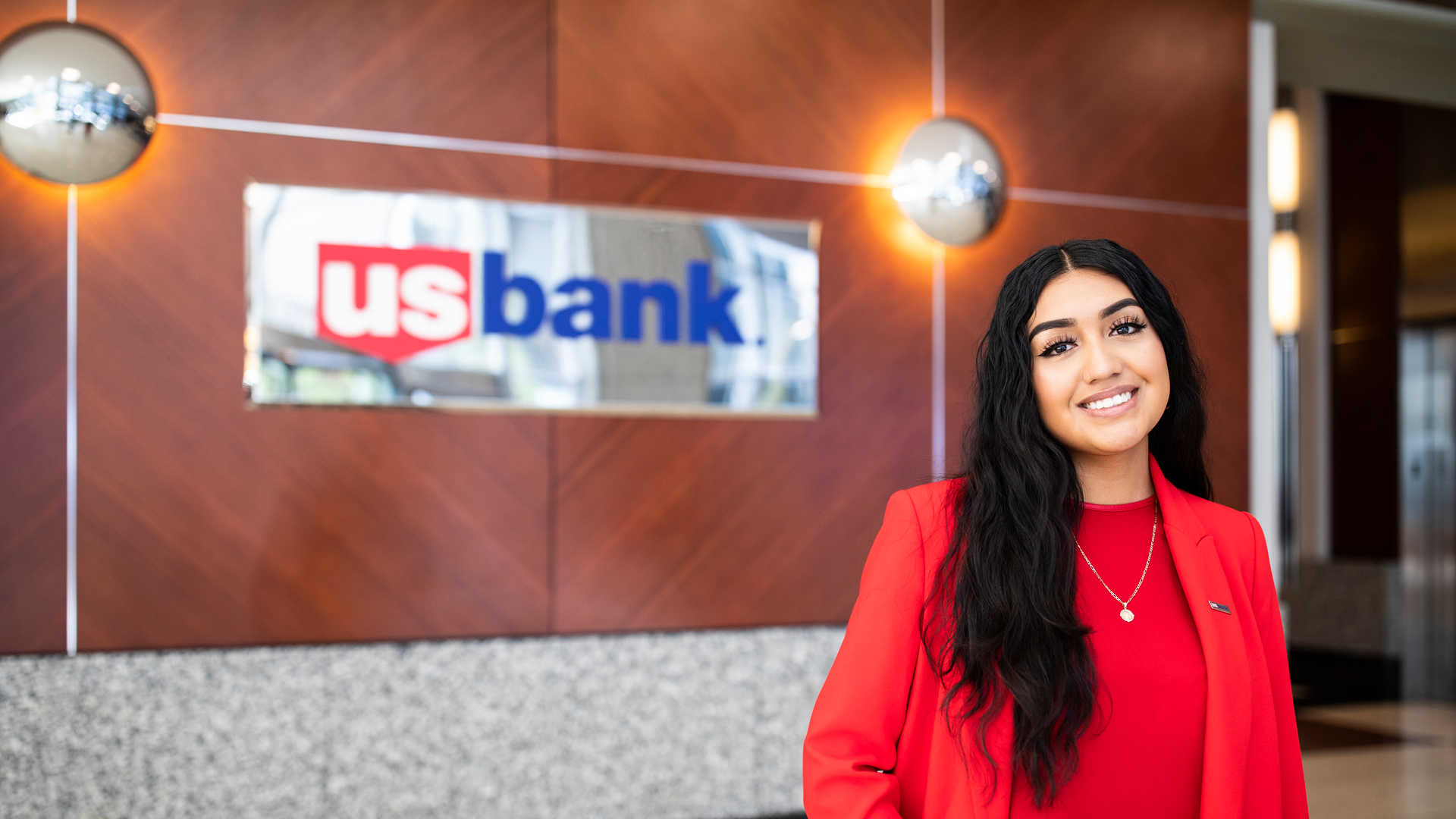 student intern poses in front the US Bank sign