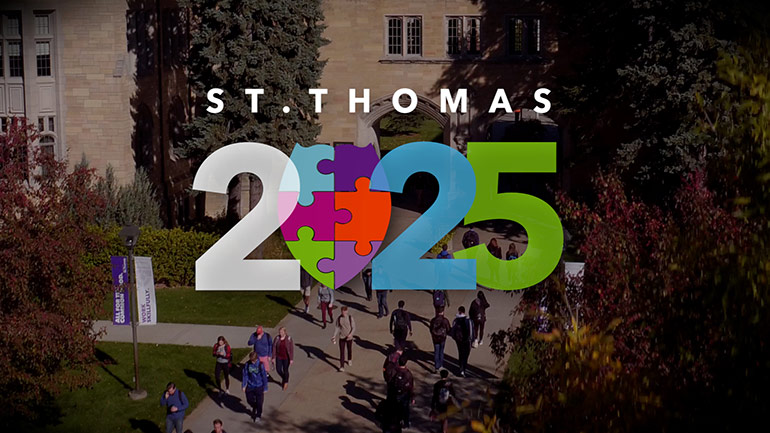 St Thomas 2025 is written over a photo of students near the arches on campus