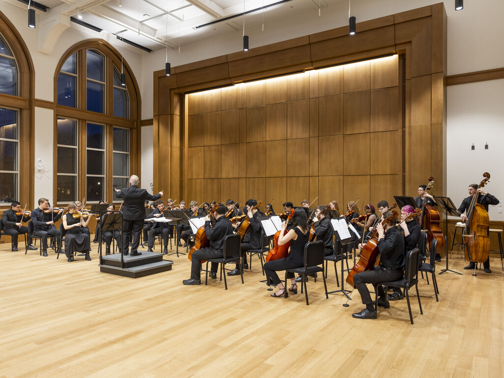 Students playing in the choral performance hall
