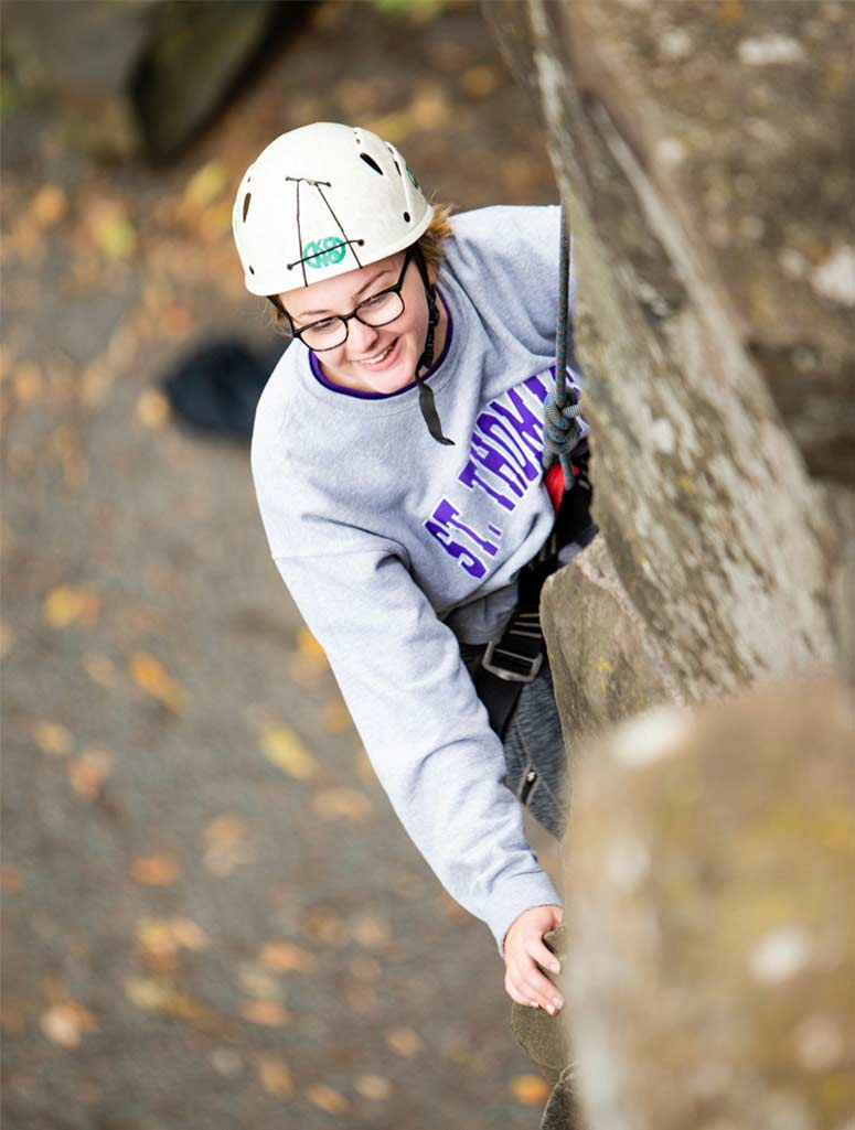 student on an epic rock climbing adventure