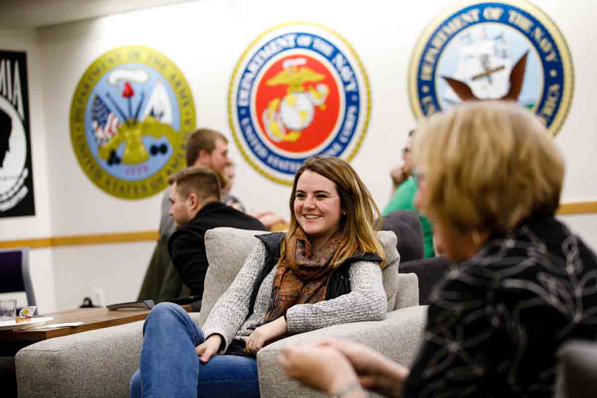 Younger student is smiling while in the Veterans Resource Center on campus.