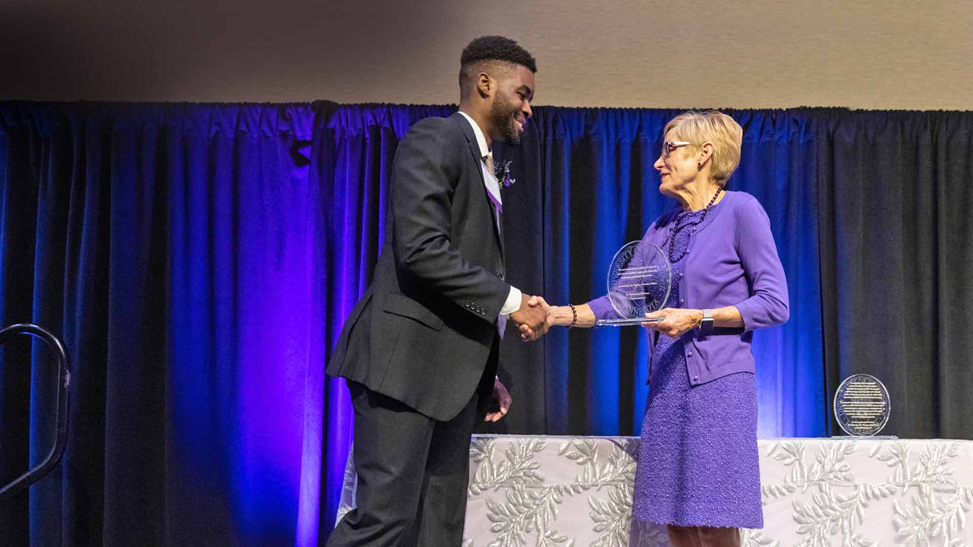 Tommie Award recipient shaking hands with president
