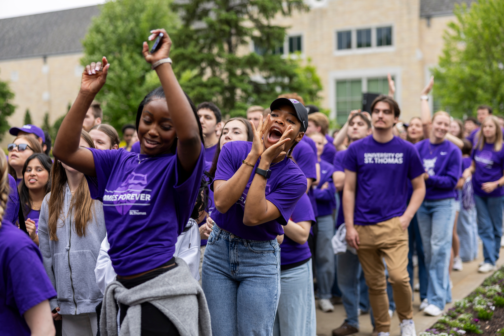 Students walking through arches