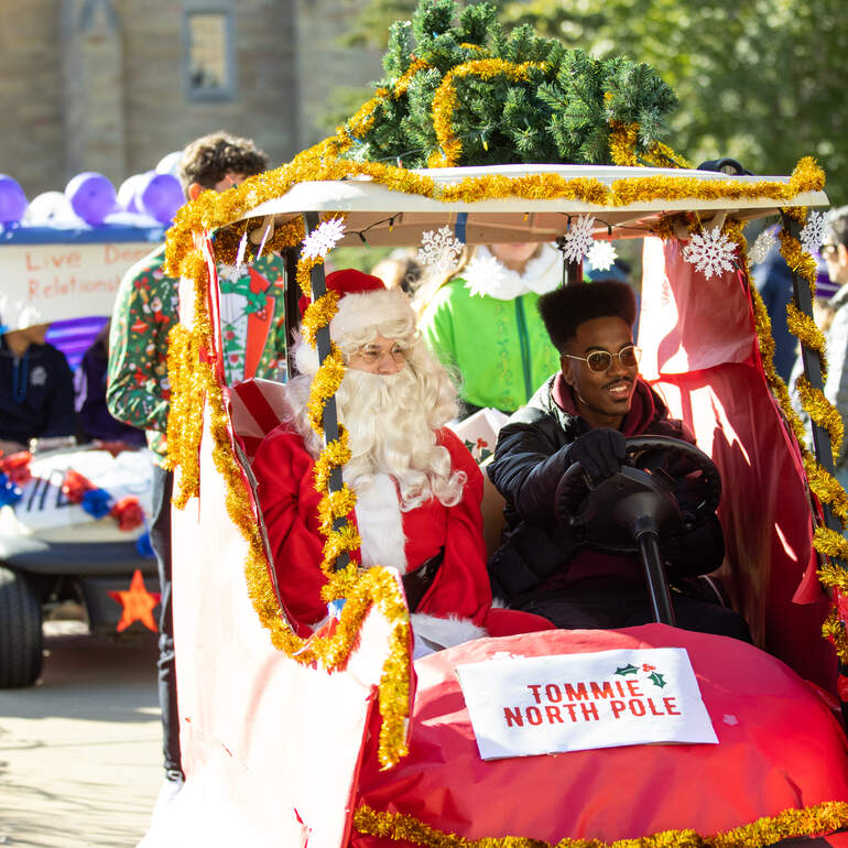 Student riding decorated golf cart