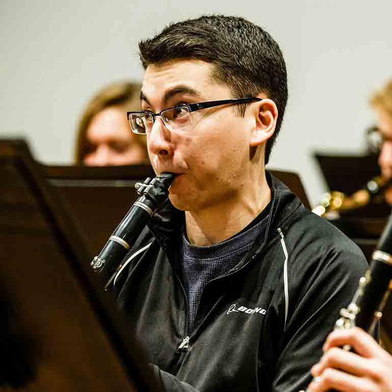 Student plays clarinet during a wind ensemble practice.
