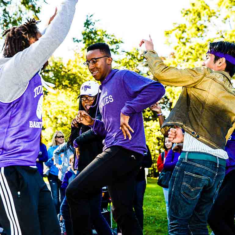 Students dance and perform in the homecoming parade.
