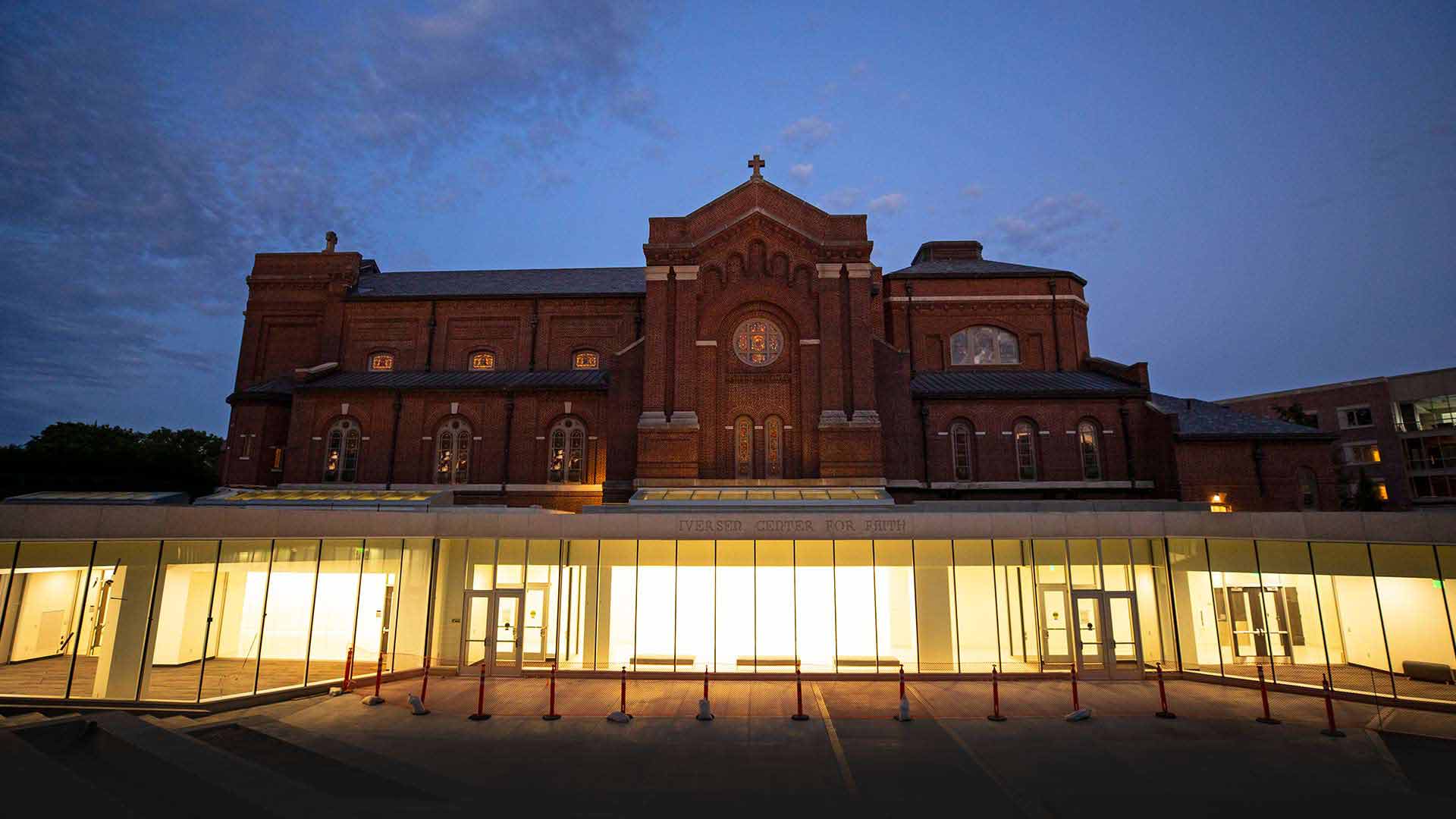 exterior view of the glass doors to the Iversen Center for Faith with the brick Chapel above it