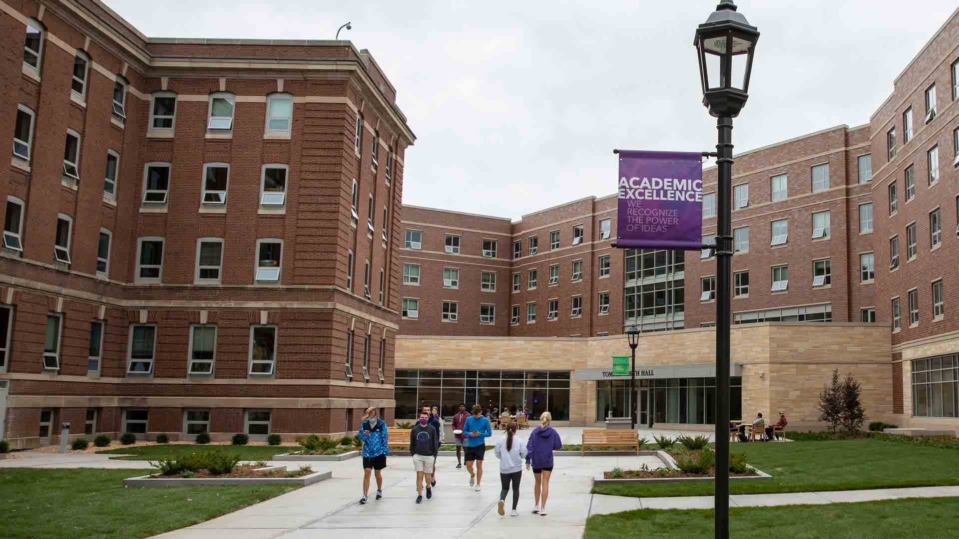 students walk in the plaza outside tommie north residence hall