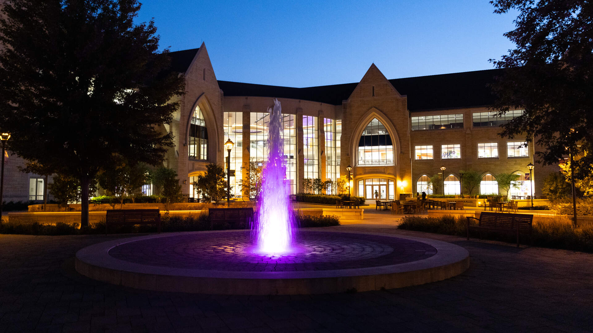 University fountain lit purple in front of the Anderson Student Center