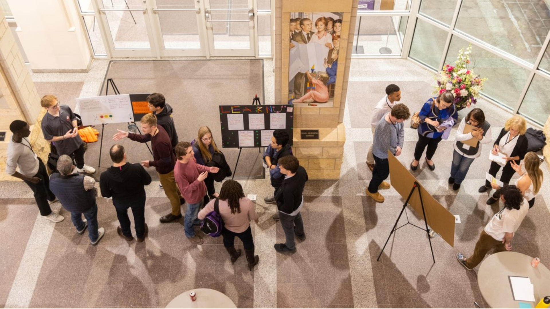 Students participate in an LLC poster board event