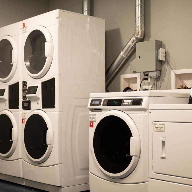 laundry room with four washing machines and two dryers