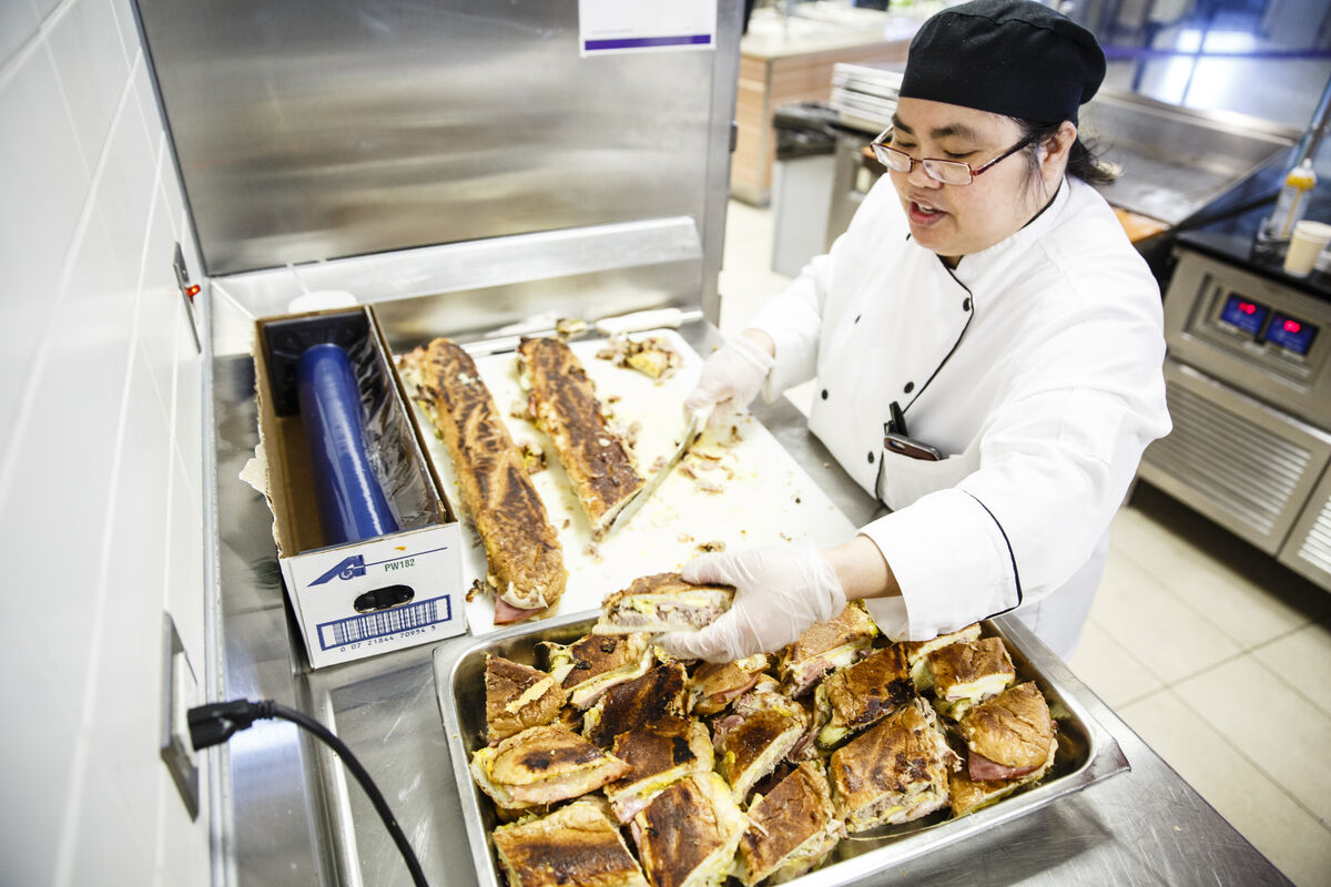A chef preparing cubano sandwiches