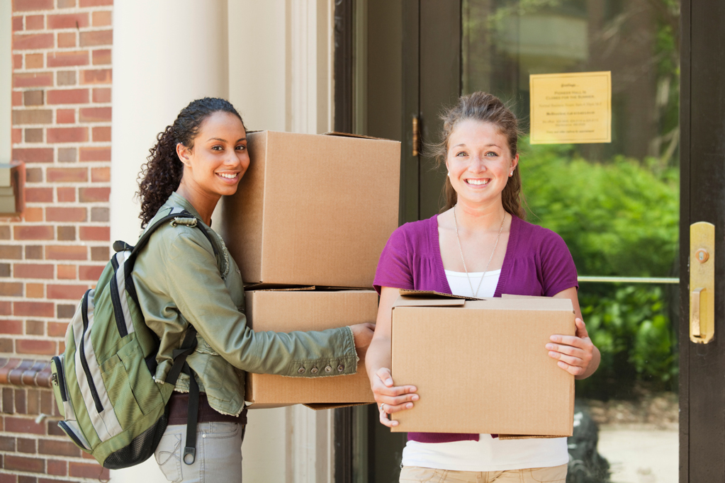 two students moving boxes