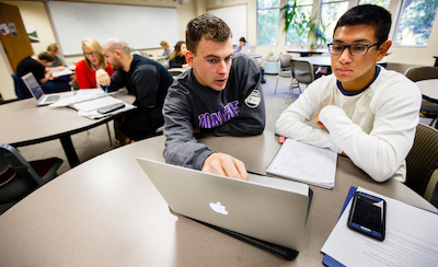 Math Resource Center tutor Michael Driscoll (left) works with a student